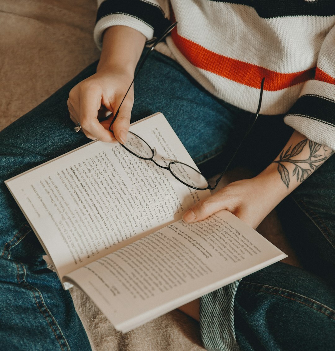 Person studying journalism ethics with open books and notes